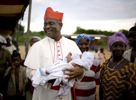 Cardinal Turkson holds a baby during a pastoral visit in Ghana (Photo: PA)