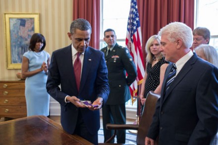 Obama holds a pocket stole that belonged to Fr Emil Kapaun (Photo: CNS)