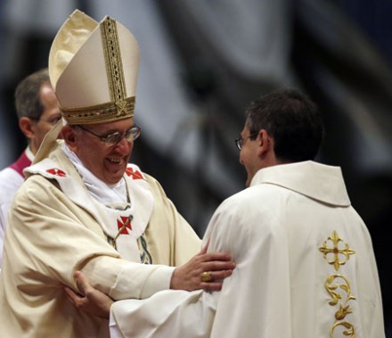 Pope Francis hugs a newly ordained priest (Photo: PA)