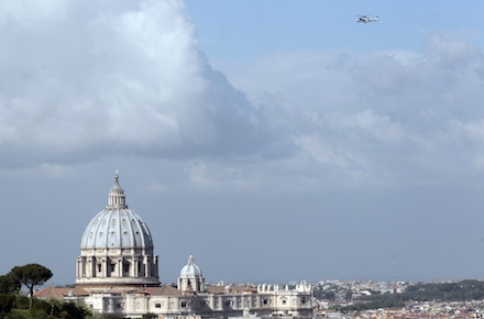 The helicopter carrying Benedict XVI back to the Vatican flies over the St Peter's Basilica (AP Photo/Gregorio Borgia)