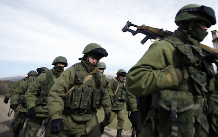 Armed men, believed to be Russian servicemen, march outside a Ukrainian military base in Crimea (CNS)