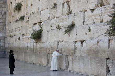 Pope Francis left a note at the Wall in accordance with Jewish tradition. Below, he embraces his two friends (Photo: PA)