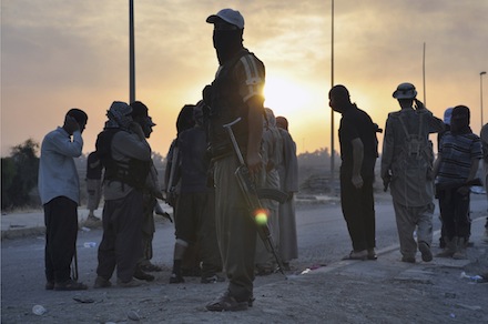 Islamic State fighters stand guard at a checkpoint in the northern Iraqi city of Mosul (CNS)